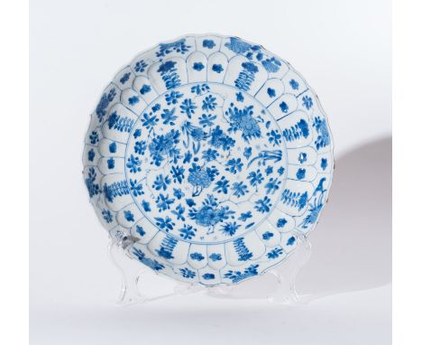 Chinese Art. A blue and white porcelain dish painted with floral motifs and bearing a six character mark at the base China, Q