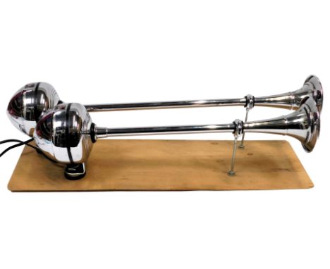 Two Lucas chrome plated 12volt commercial vehicle horns, mounted on a wooden board, each 67cm long.