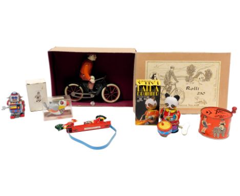 Various tinplate toys, including an Amusing Gay Panda Drummer, a clockwork tinplate robot, a DBS Roly 230 wind up cyclist, bo