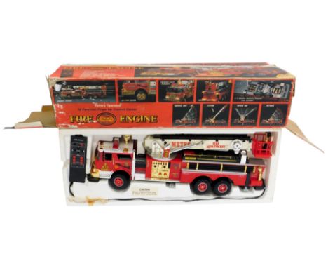 A New Bright battery operated battery operated remote control fire engine, with twelve function fingertip control centre, box