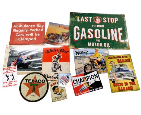 Various reproduction signs, including an Ambulance Bay Illegally Parked Cars Will be Clamped sign, John McGuiness metal sign,