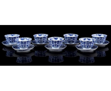 7 porcelain cups and saucers with contoured rim, parsley decor and bird in the sky, cups Qianlong marked and saucers Kangxi m
