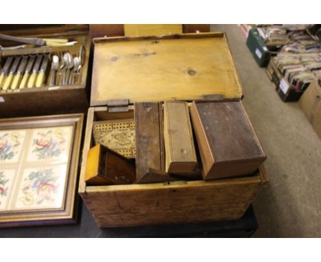 A pine box containing various games to include dominoes, cribbage boards, draughts etc. 