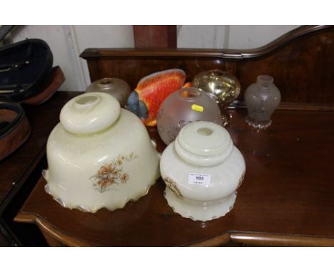 A pottery model of a fish; and a collection of glass light shades 