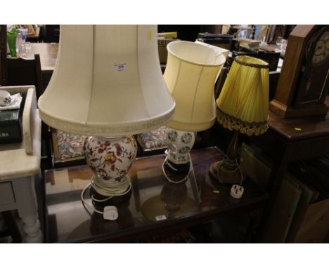 Two china table lamps and shades together with a wooden table lamp 