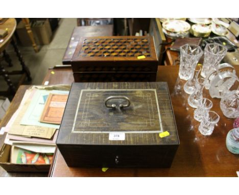 A specimen wood trinket box containing various playing cards and a cash box disguised as a Victorian sewing box