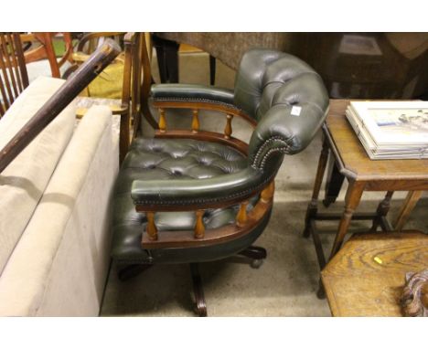 A green leather button back desk chair 