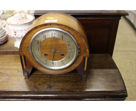 An Art Deco walnut cased mantel clock, pendulum on rostrum