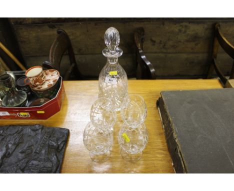 A cut glass decanter together with four brandy balloons 