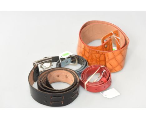 A group of vintage leather belts including a striking orange faux crocodile