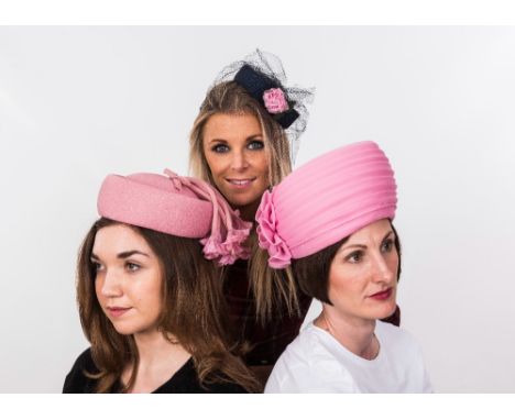 A hatbox containing a group of five vintage hats 1950's net fascinators, 1980's pink turban hat etc