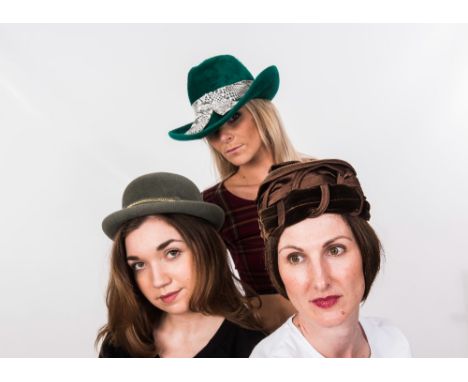 A hatbox containing four vintage hats including a 1970's green fedora with faux snakeskin band by Mitzi Lorenz, a pink toque,