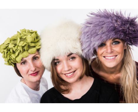 A group of vintage hats including orange feather, green "leaf" etc