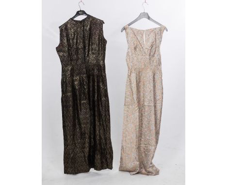 Two 1960's evening dresses, one sleeveless in black and gold, the other belted with floral print