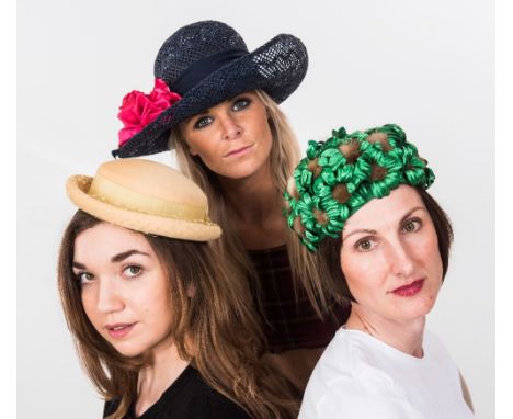 A hatbox containing five vintage hats including a 1950's green faux feather and fut hat, a taupe ribbon trimmed hat of simila