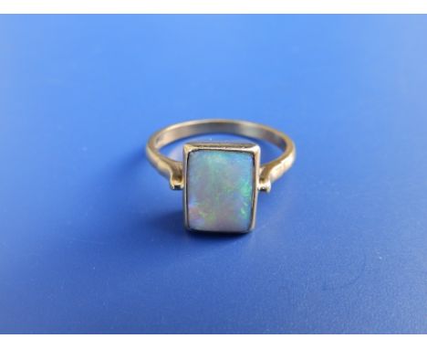 A rectangular opal solitaire ring set in 18ct gold.  Finger size N.