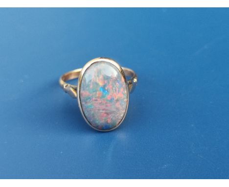 An oval black opal set ring in '15ct'.