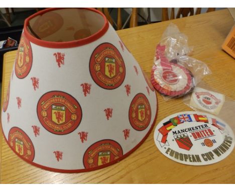 A small Manchester United 1968 European Champions poster, an MUFC lamp shade and rosettes.