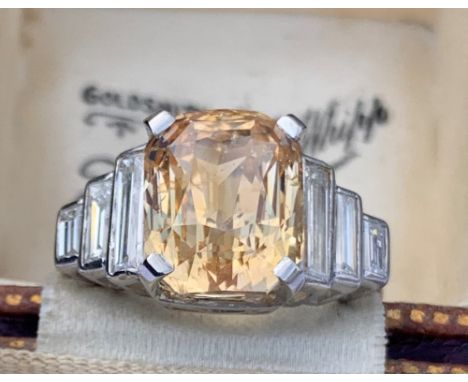 A certified natural orange/yellow Sri-Lankan sapphire &amp; diamond ring, the rectangular cut-cornered central sapphire weigh