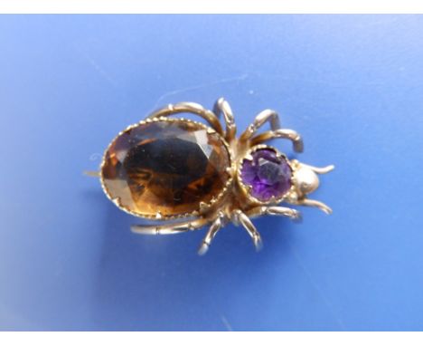A citrine &amp; amethyst set yellow metal spider brooch,  1" across.