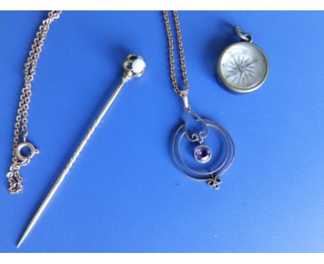 An amethyst set yellow metal pendant on necklace chain, an opal set pin and a small silver compass. (3)