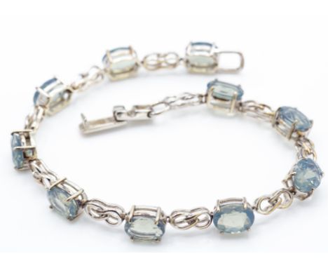 A hallmarked&nbsp; 9ct gold green fire opal bracelet. The bracelet set with 10 oval cut opal (approx 8ct) with link spacers o