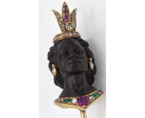 A fine 19th century gold ruby emerald and diamond Blackamoor stick pin. The pin depicting the head of a regal woman. The figu