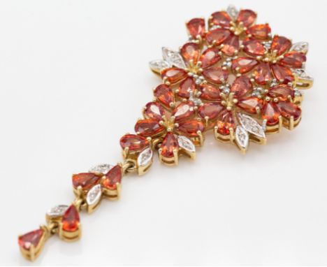 &nbsp;A large hallmarked 9ct gold and 'sunset ruby' sapphire and diamond necklace pendant. The pendant of cascading naturalis