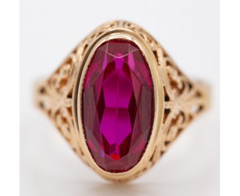 A post 1925 Russian 583 - 14ct gold and synthetic ruby ring. The ring with facet cut oval stone within rub over mount and pie