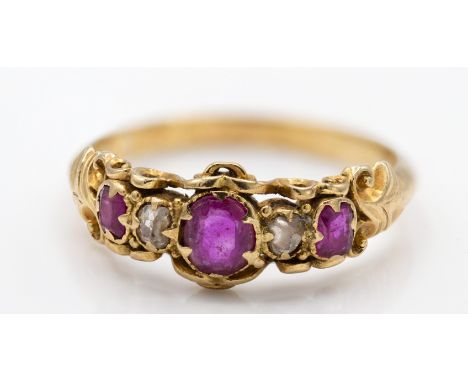 A 19th century gold, ruby and diamond 5 stone ring. The ring with central oval cut ruby&nbsp; within mixed cut diamonds and r