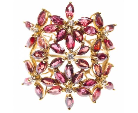 A hallmarked 9ct gold ruby and sapphire floral cluster ring. The ring set with marquise Malawi ruby (approx total 3.68ct - ap