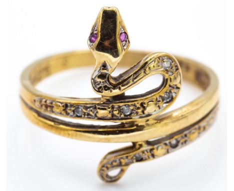 A hallmarked 9ct&nbsp; gold ruby &amp; white stone snake ring. The ring set with ruby eyes with mixed cut white stones to the