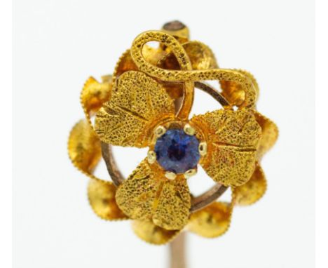 A 15ct gold and sapphire adorned 19th century Victorian stick pin. The flower heat top within filigree worked surround on pin