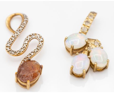 A hallmarked 9ct red rutile quartz and diamond snake necklace pendant. The pendant in the form of a snake set with an oval mi