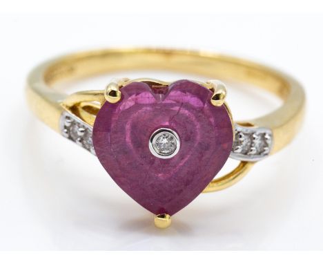 A hallmarked and signed Glenn Lehrer 9ct gold ruby and diamond Torus ring. The ring being set with a heart shaped torus cut r