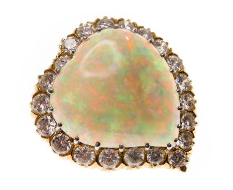 A gold opal and diamond pendant brooch in the form of a witches heart. Framed by 21 round brilliant cut diamonds, estimated d