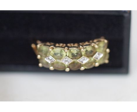 9ct gold ring set with 10 light green stones and diamonds