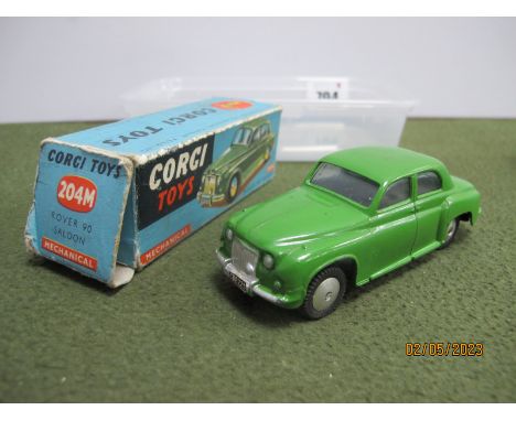 A Boxed Corgi Toys #204M Diecast Model Rover 90 Saloon, mid green body, minor chipping to paintwork, applied paper registrati