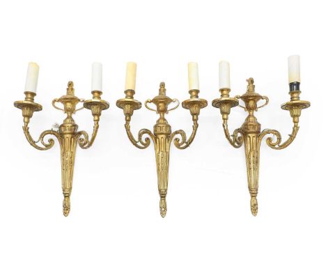 A group of three French gilt metal wall appliques, 20th century, each surmounted by an urn,42cm high (3) Condition ReportWear