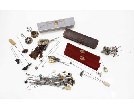 A collection of hat pins, 19th century and later, to include silver, agate, Union flag and paste examples, a brass mounted ag