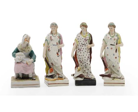 Three Staffordshire pearlware figures, depicting 'Peace', early 19th century, the classical figure putting a torch to instrum