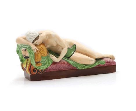 A Staffordshire pottery figure of Lucretia, c.1800, the heroine draped on a daybed, with enamel decoration,28cm wide13.5cm hi