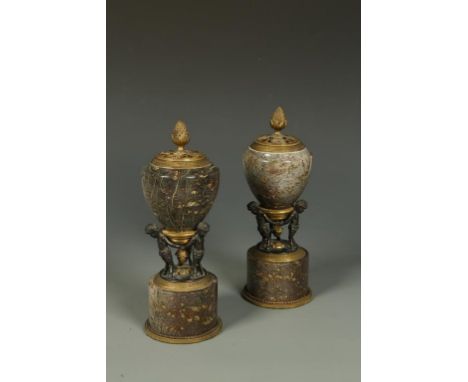 A PAIR OF SERPENTINE BRONZE AND GILT BRONZE VASE-SHAPED MANTELPIECE ORNAMENTS with reversible lids fitted with a detachable s