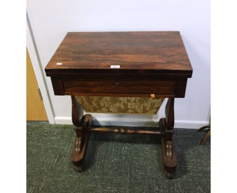 A REGENCY ROSEWOOD SEWING AND CARD TABLE, the rectangular fold-top with a baise-lined playing surface above a flush fitting f