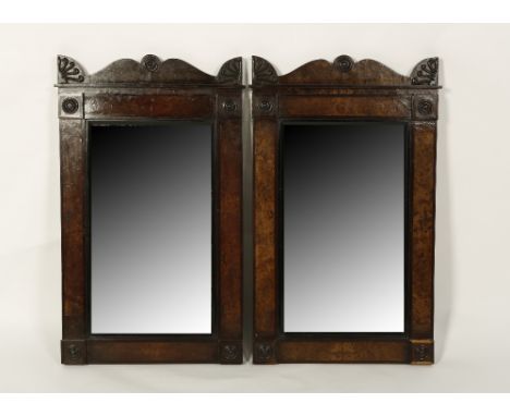 A PAIR OF WALNUT AND EBONISED FRAMED WALL MIRRORS in the manner of George Bullock, each with rectangular plates within flat f
