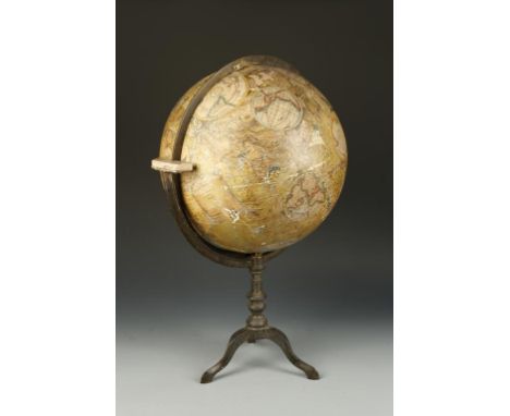 A TERRESTRIAL GLOBE ON STAND, the globe surface with a number of later applied patches, within a graduated brass ring, on a c