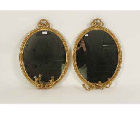 A PAIR OF REGENCY STYLE GILT WOOD GIRANDOLE MIRRORS, with oval back plates with tied rope effect borders, each with twin cand