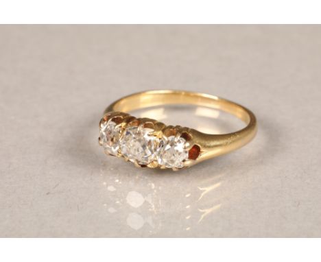 Ladies three stone diamond ring, on yellow metal shank, central stone 0.33 carats, stone either side 0.25 carats. Ring size K