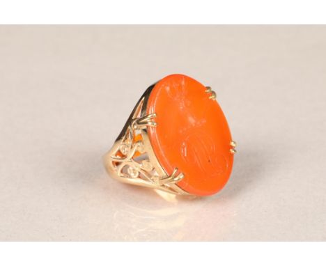 9 carat gold seal ring, pierced shoulders set with an oval orange hardstone tablet.  Ring size P.