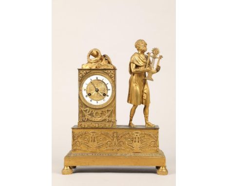 19th century French gilt metal mantel clock, with a mounted robed man playing a lyre, time piece with enamel chapter ring wit